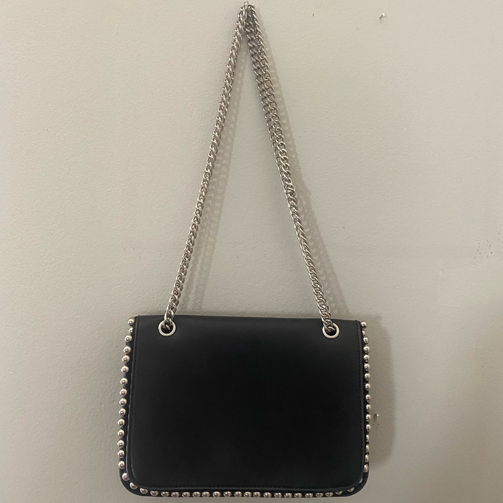 Like new purse in black faux leather with silver details